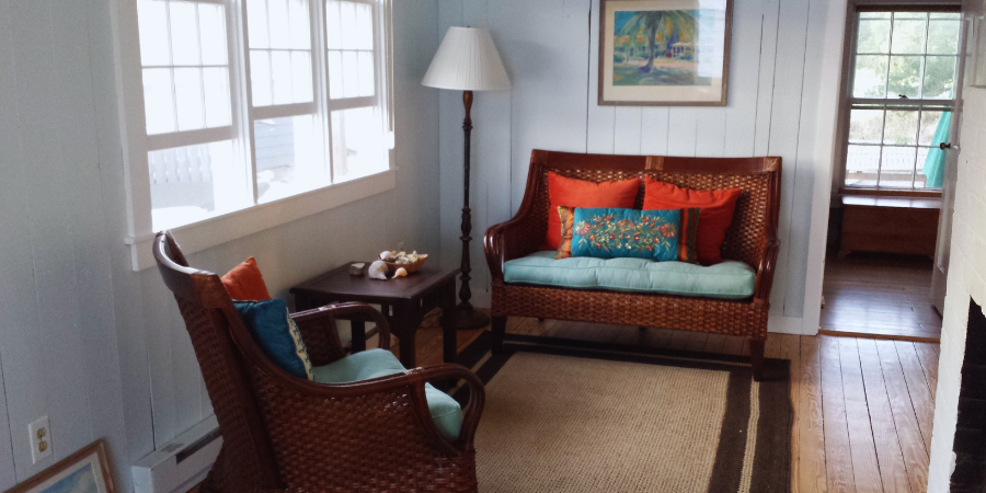 sunroom addition with woven brown chairs by raymond design build in connecticut