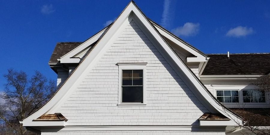 white house exterior with open window in attic by Raymond Design in Connecticut