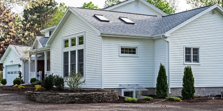 white house exterior with brown mulch front yard