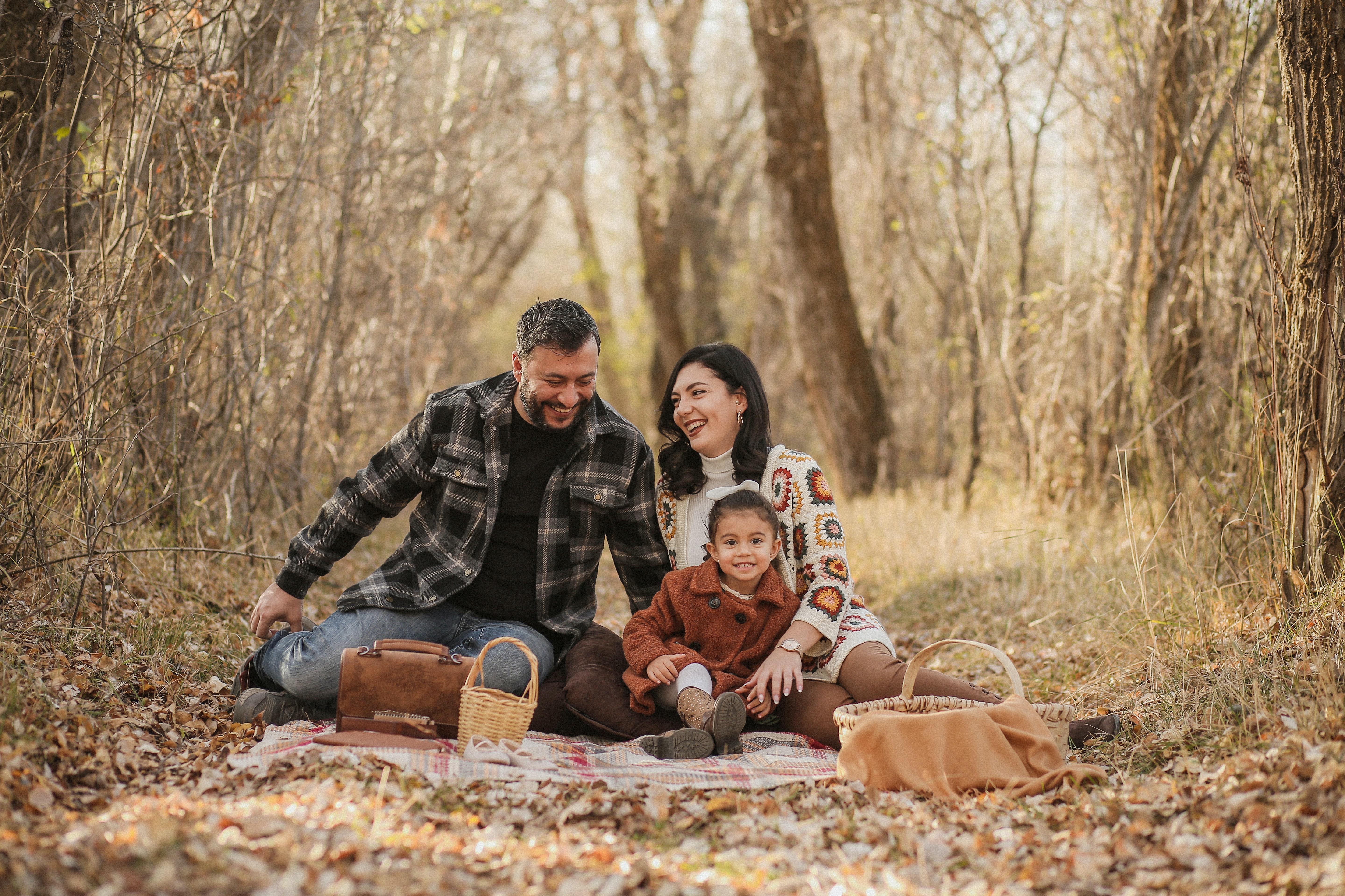 Smiling family having a picnic in an outdoor foresty area